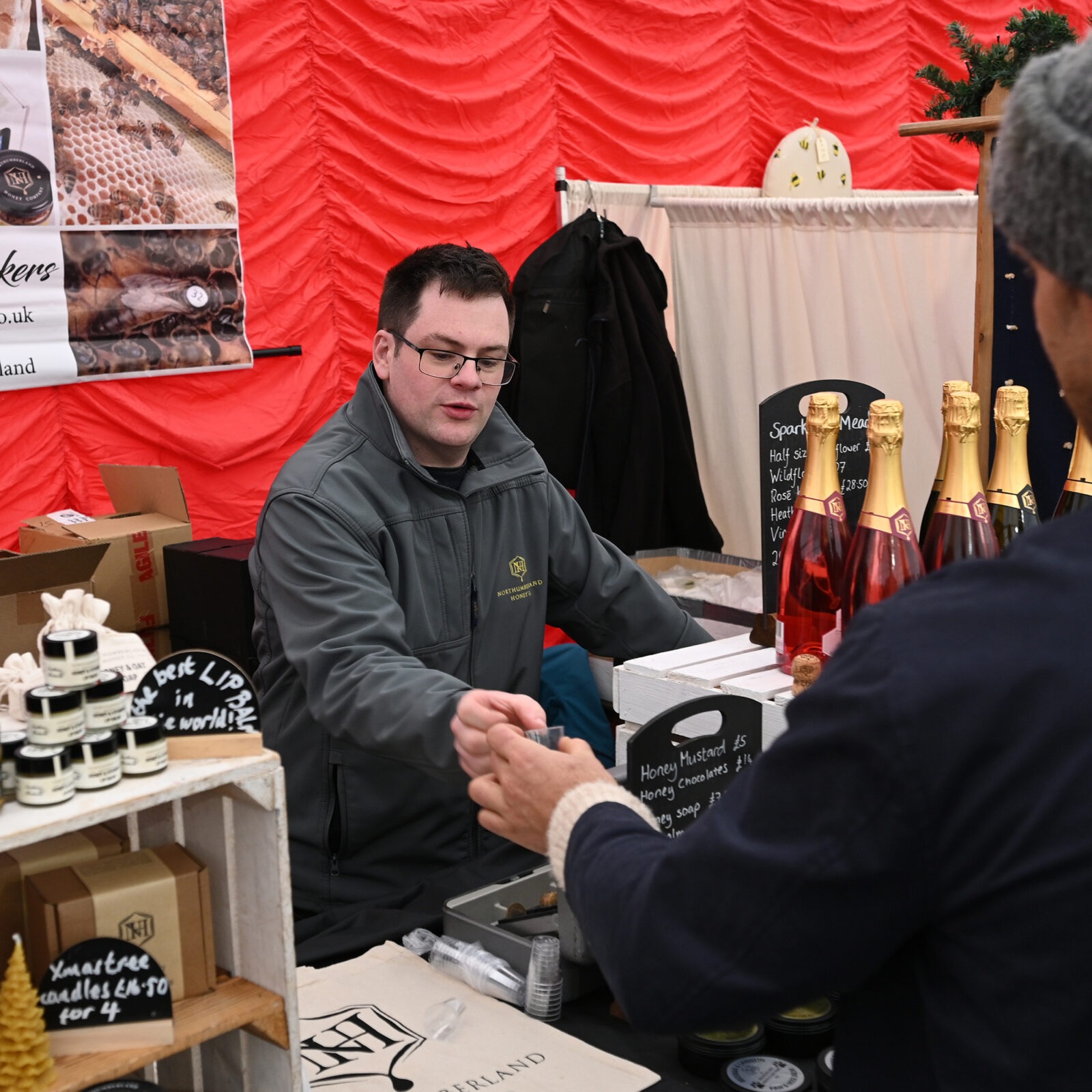 A sales transaction at Northumberland Honey stall