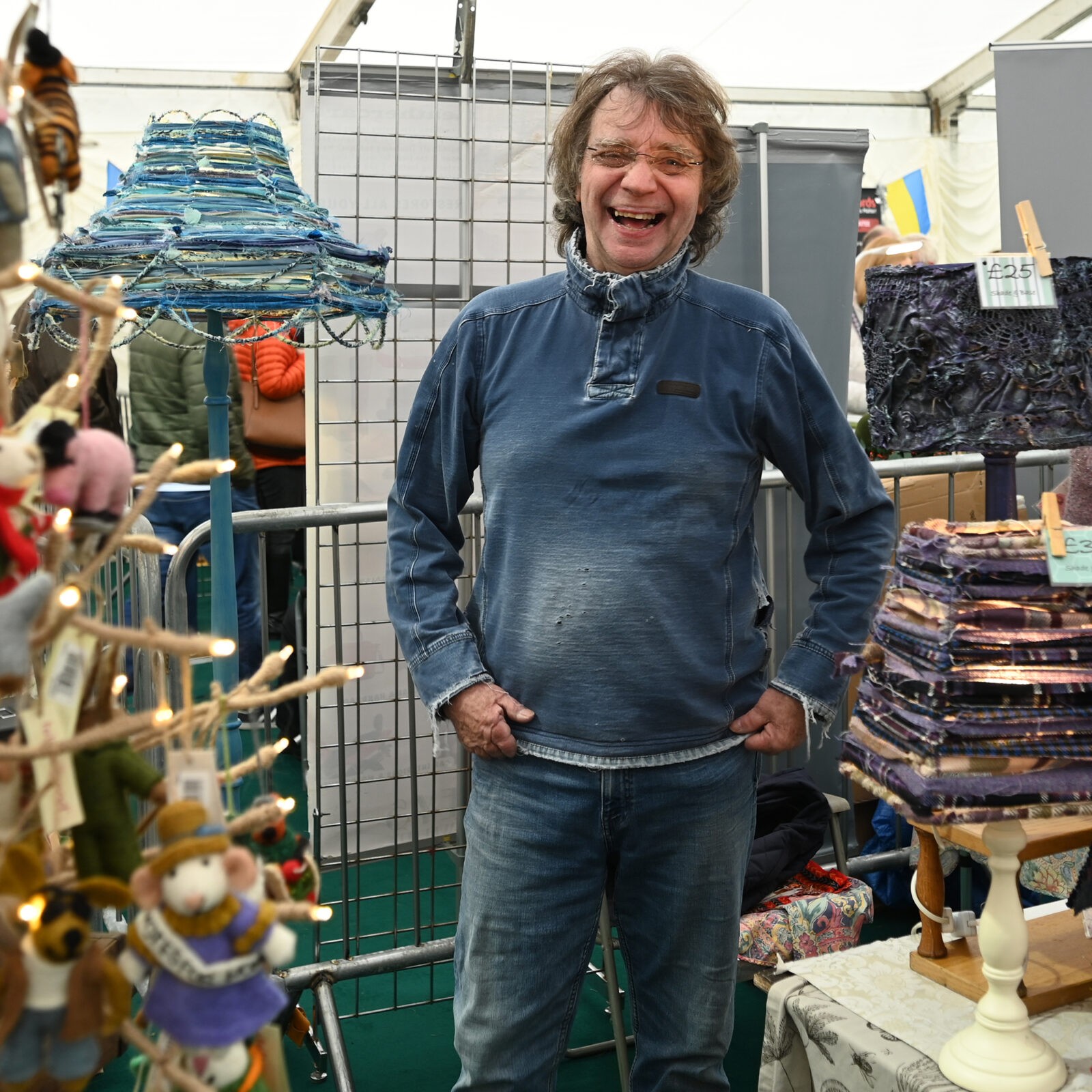 A man laughing selling lamps