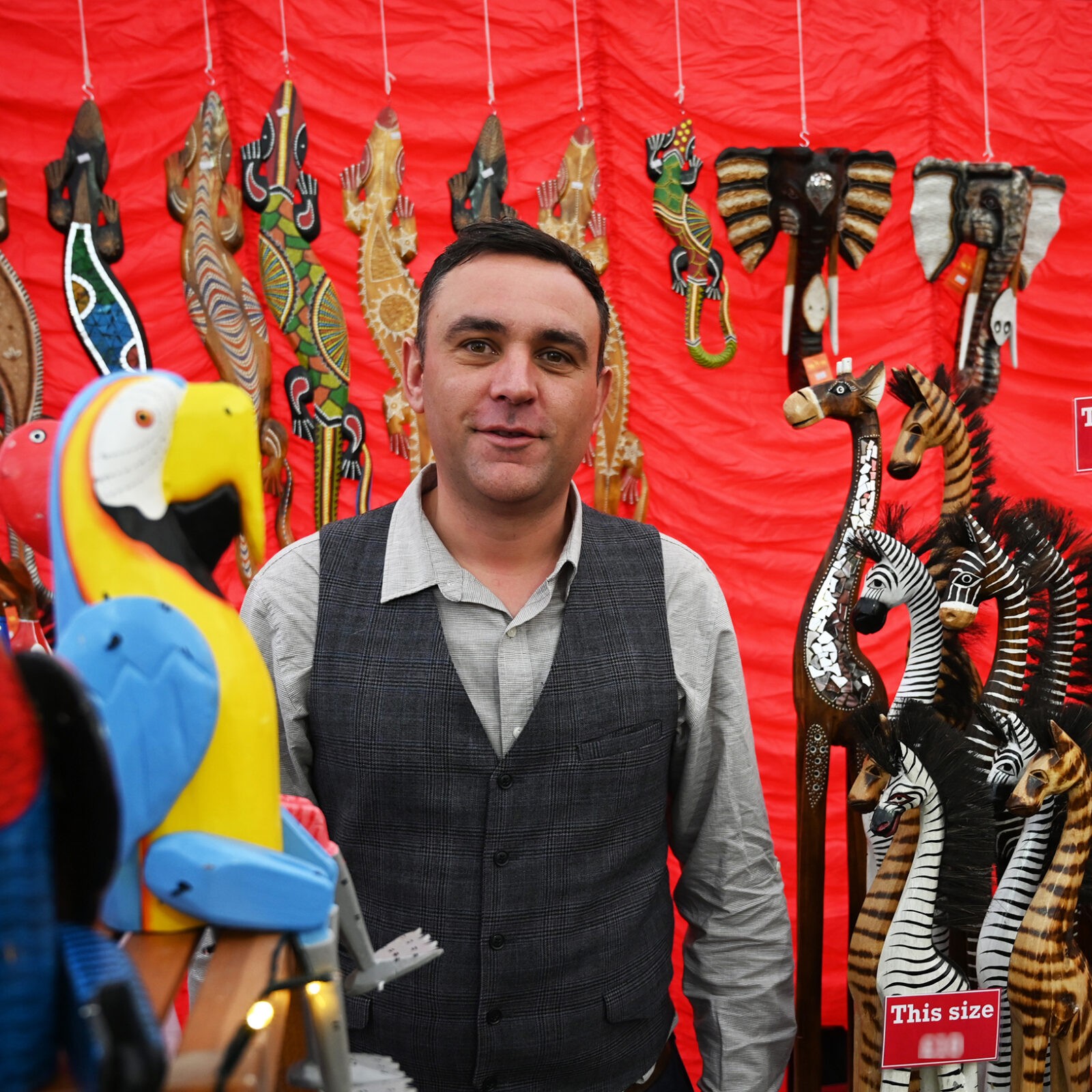 A man selling wooden animals