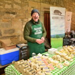 A man selling cheese