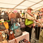 A man showing off a shoulder bag