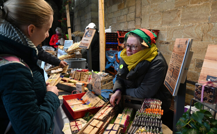 A lady selling bars of chocolate