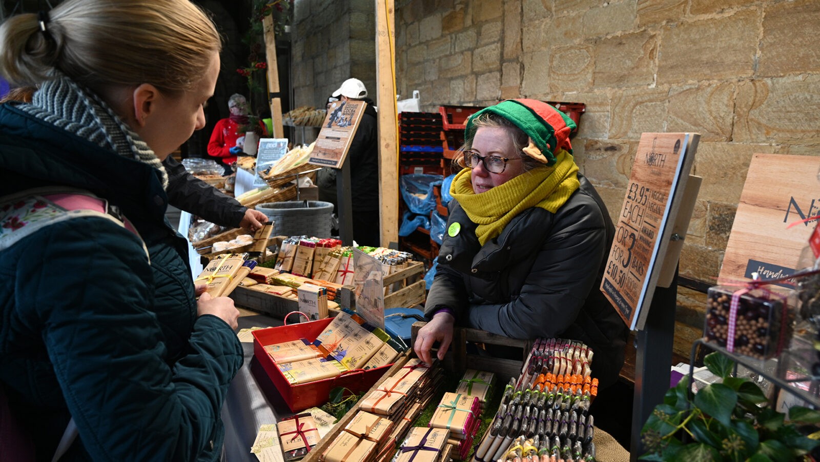 A lady selling bars of chocolate