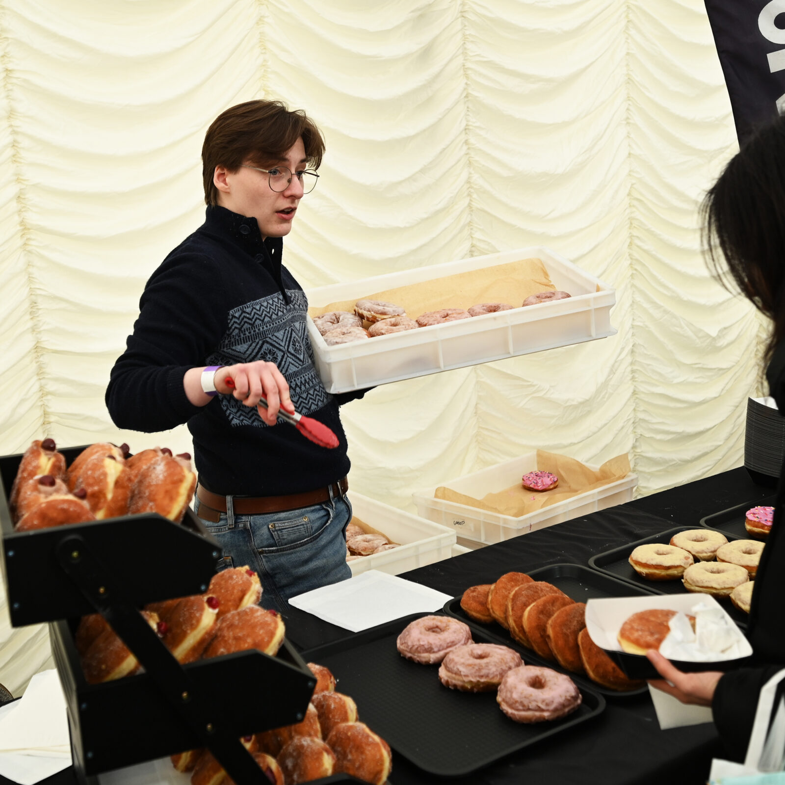 A man selling doughnuts
