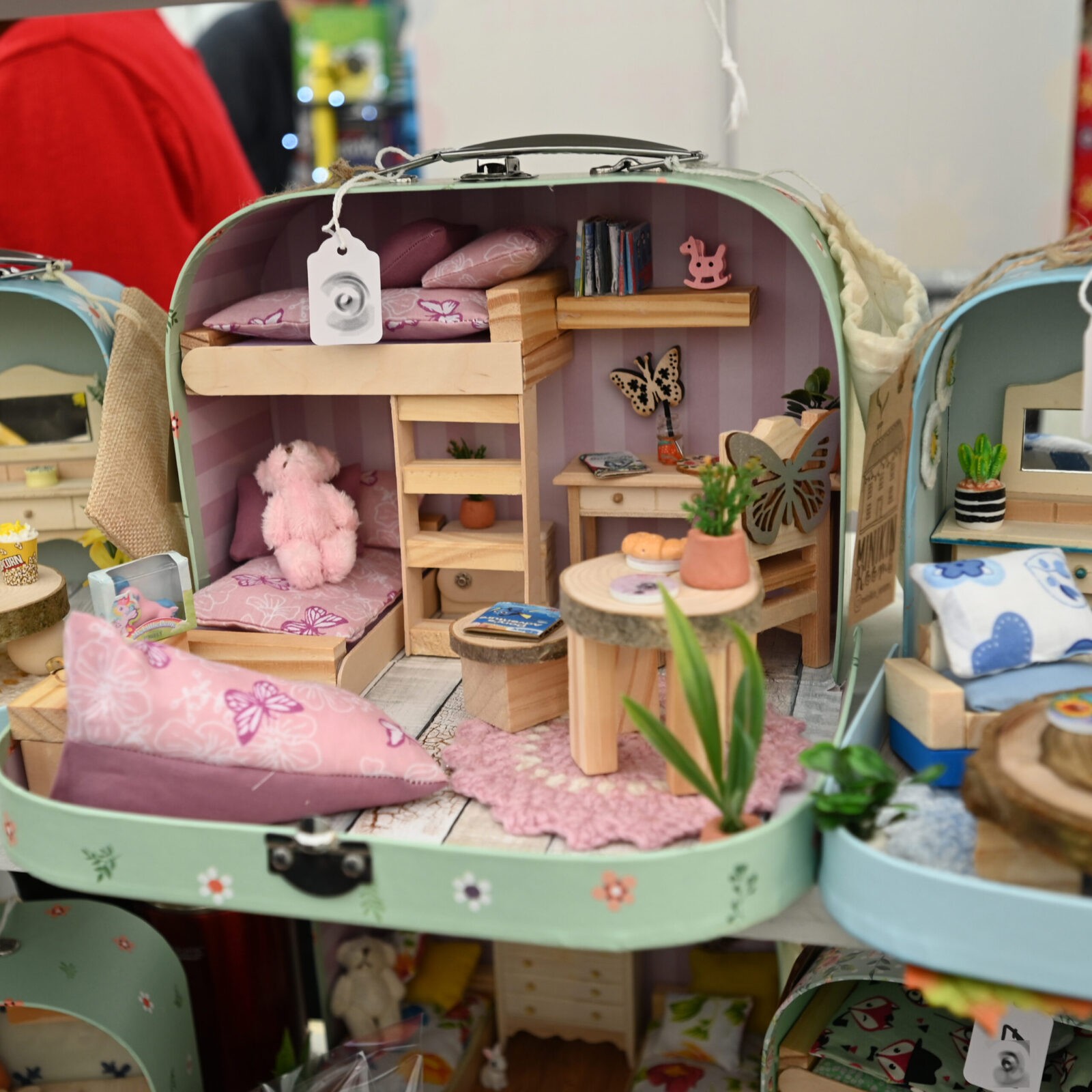 A small case containing a miniature dolls house