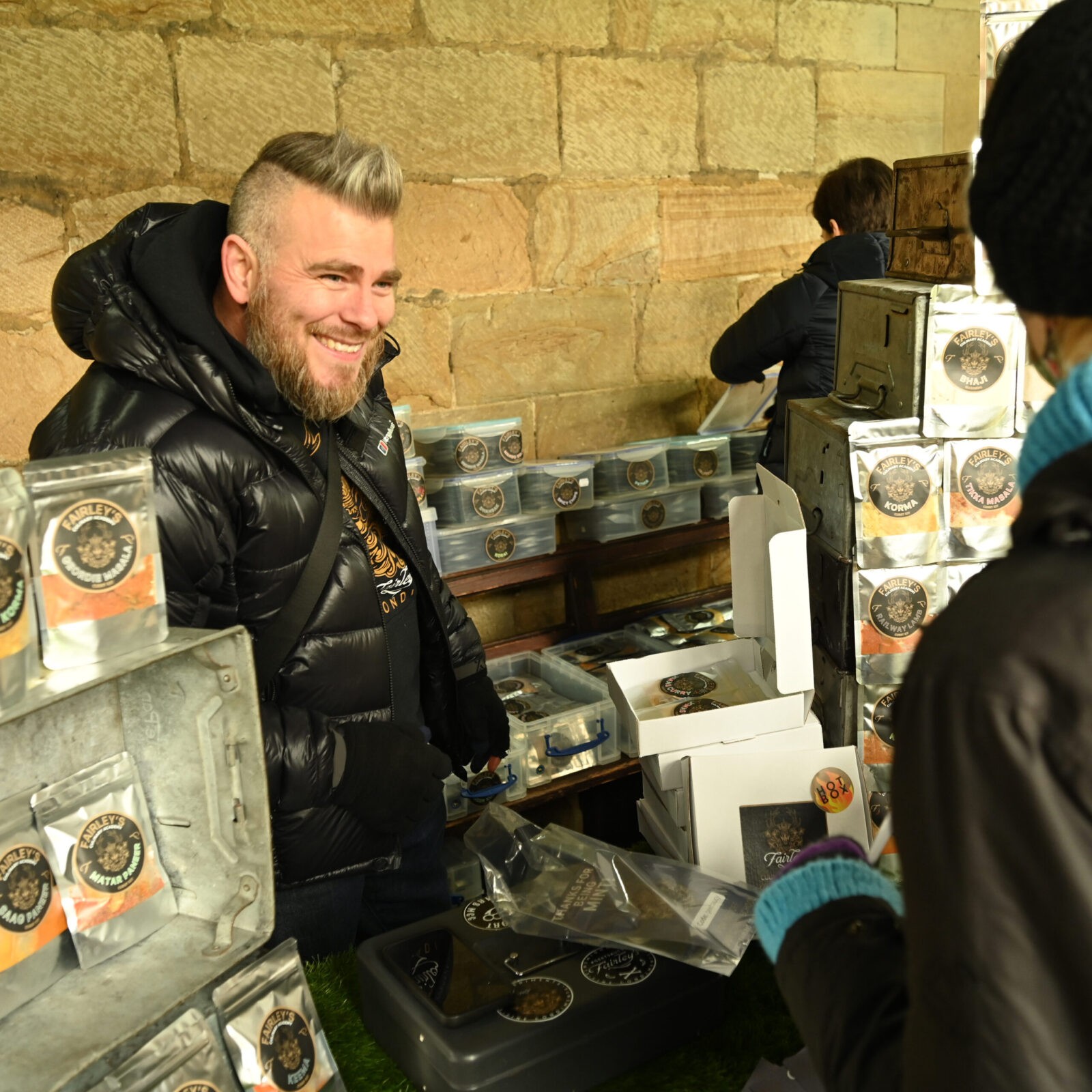 A man selling curry sauces