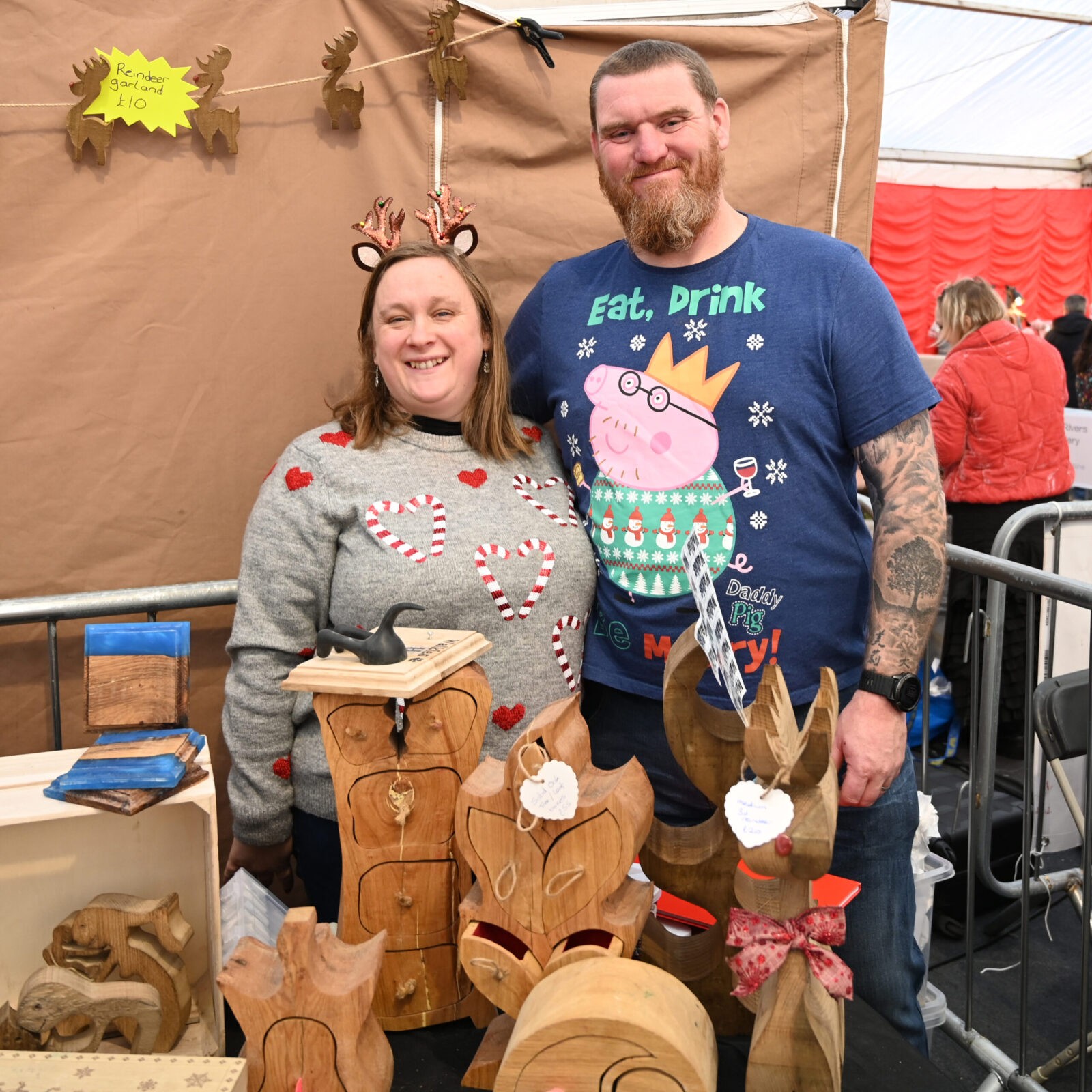 A couple selling wooden objects