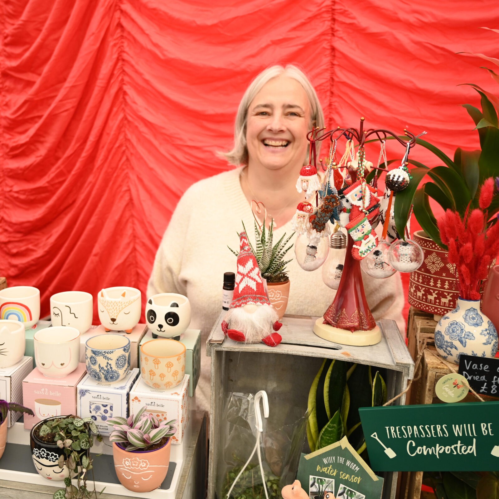 A woman selling Christmas decorations and plant pots