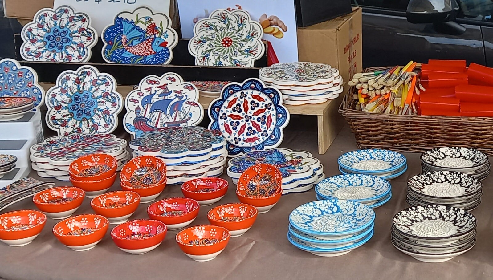 A display of colourful ceramic bowls and plates