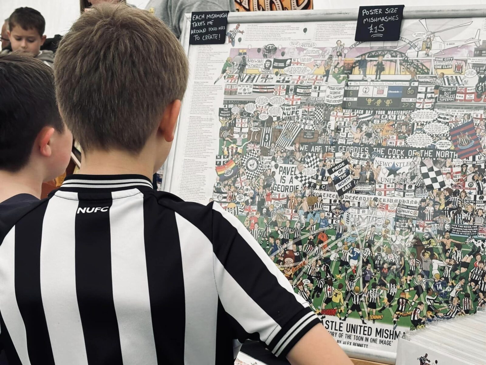 Two children looking at Mishmash man artwork of Newcastle football club
