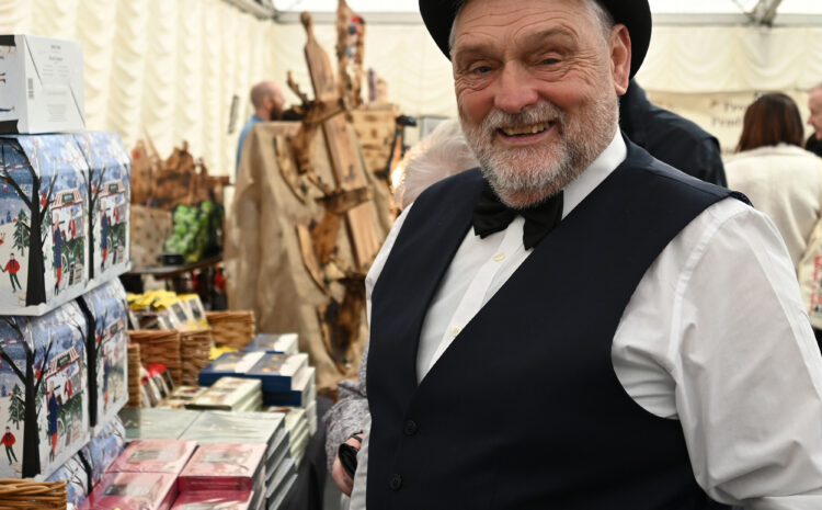 A smiling man in a bowler hat