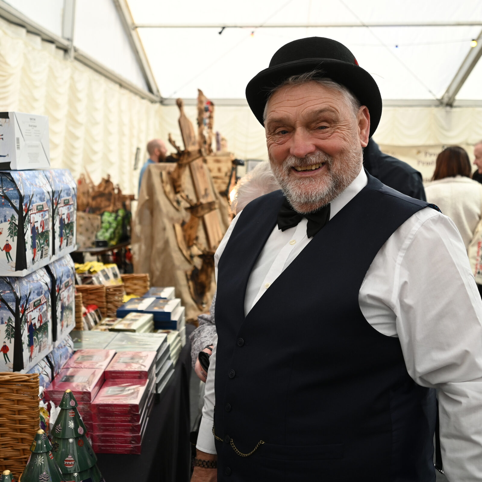 A smiling man in a bowler hat