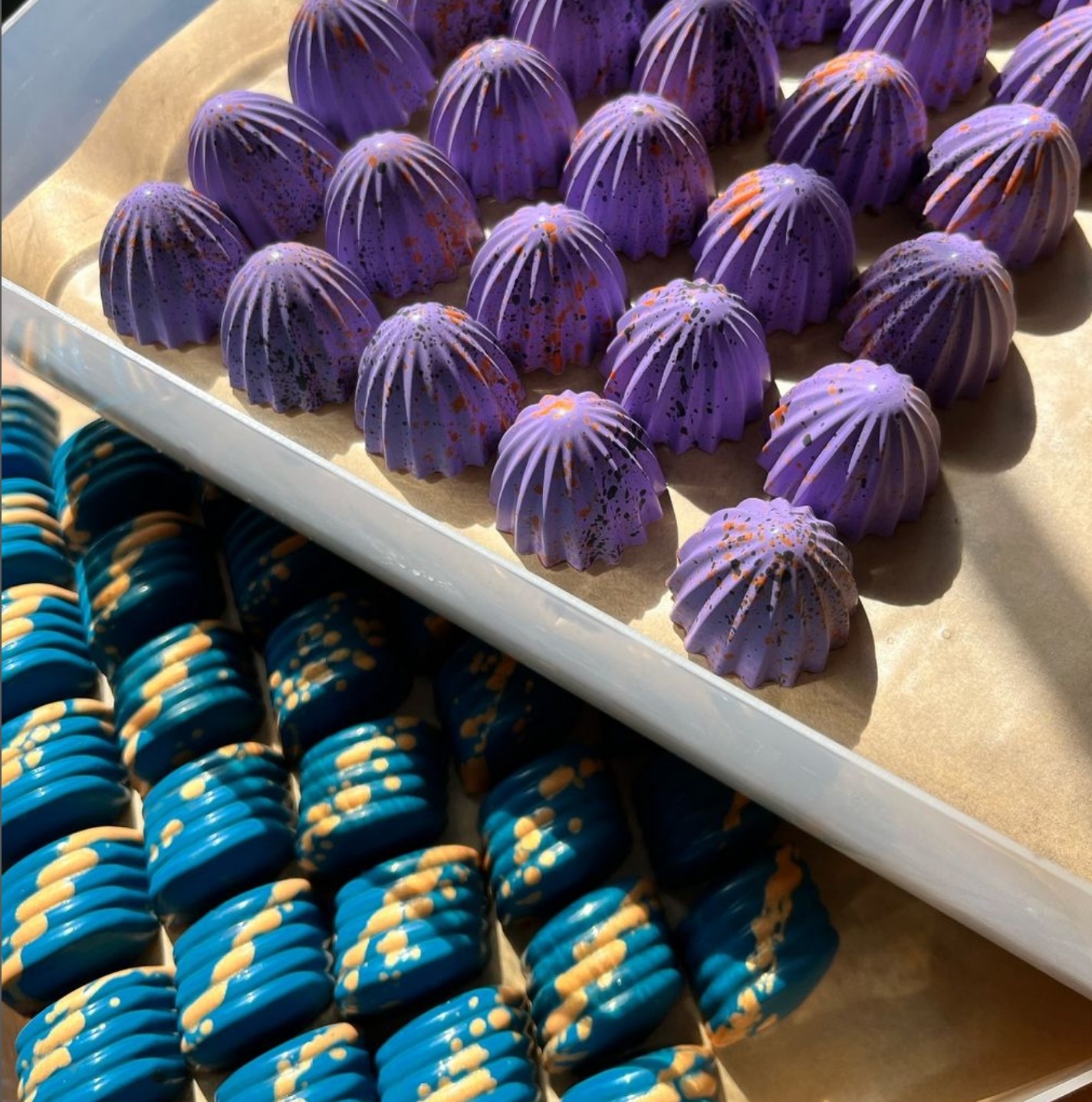 Trays of purple and blue chocolates