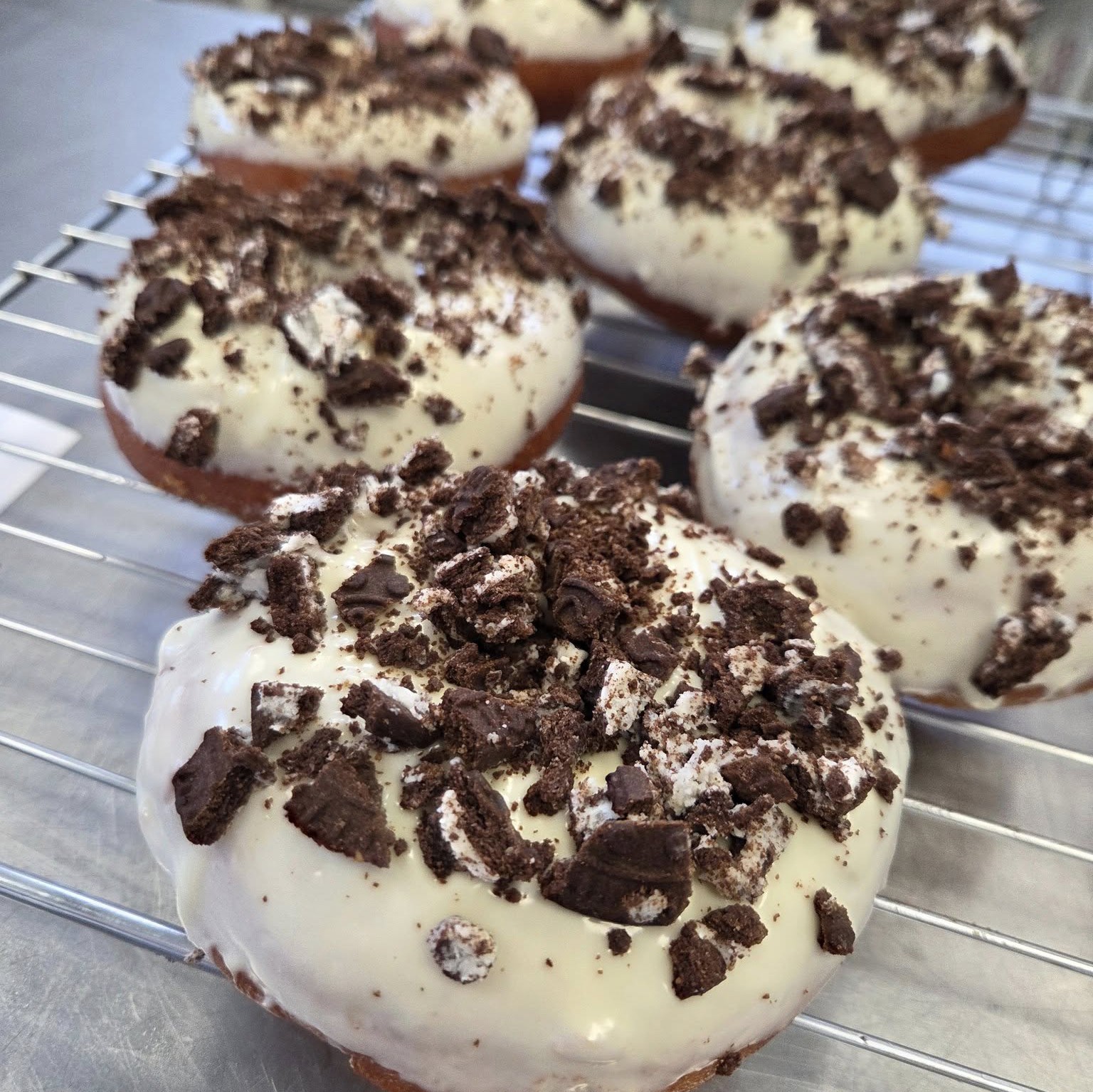 Doughnuts topped with white chocolate and chocolate crumbs