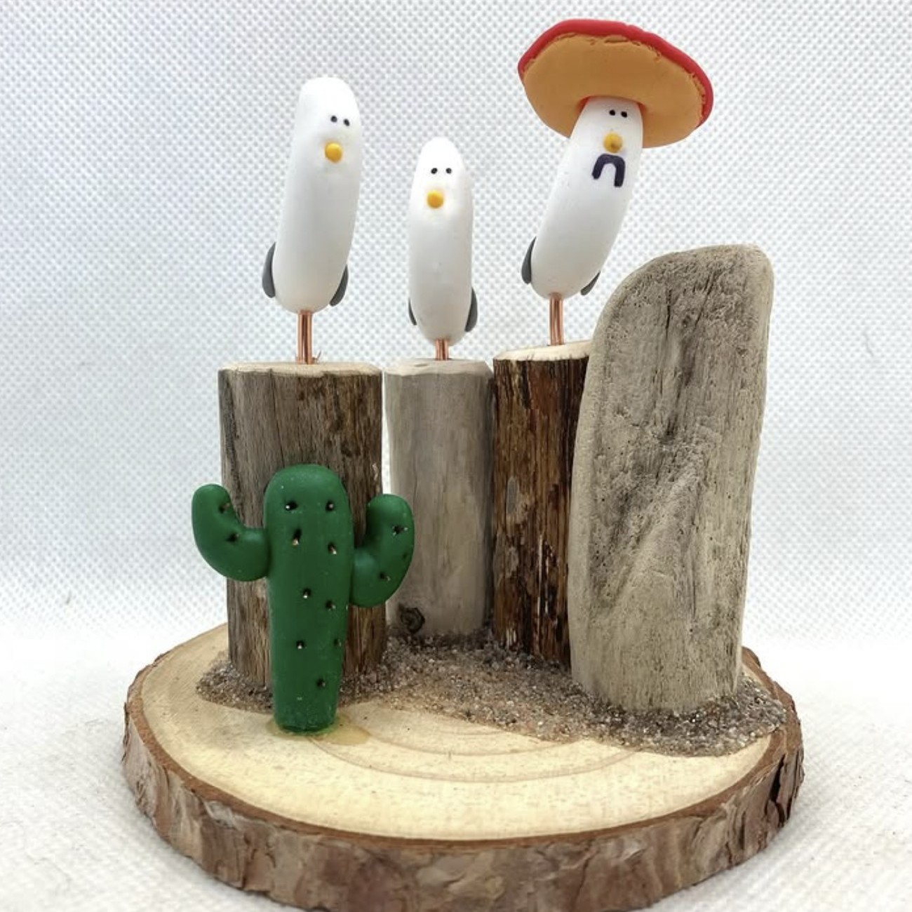 A wooden ornament featuring three gulls