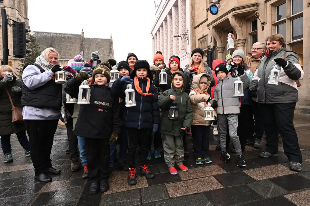 A group of scouts with lanterns