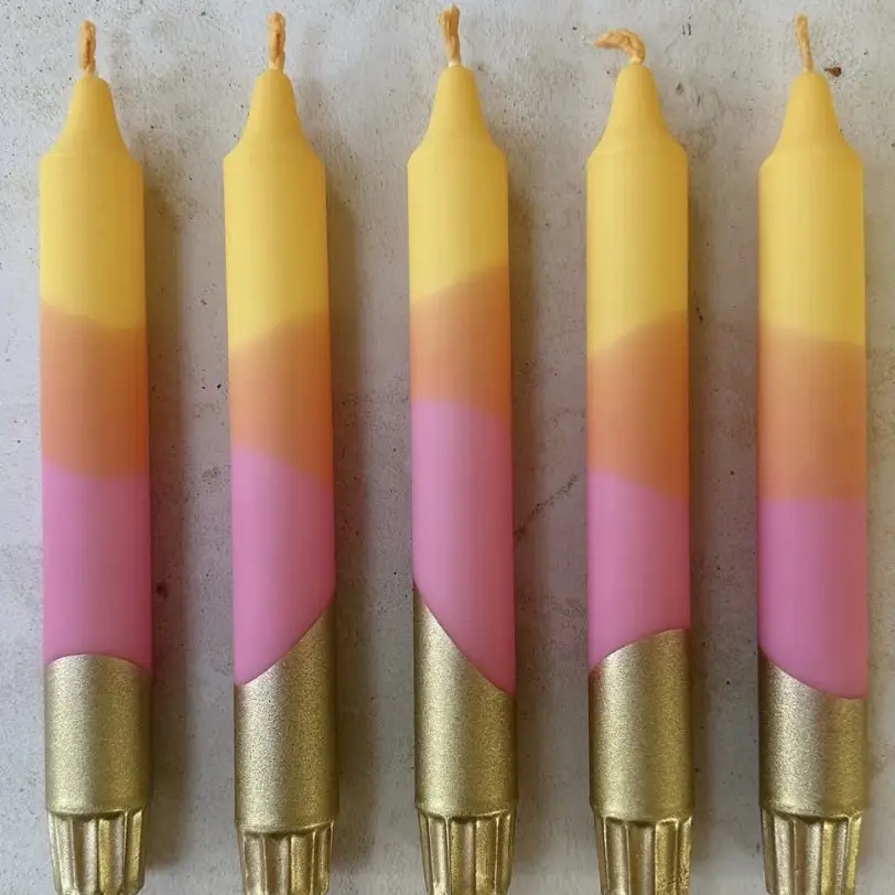 A selection of bold, pink, orange and yellow candles