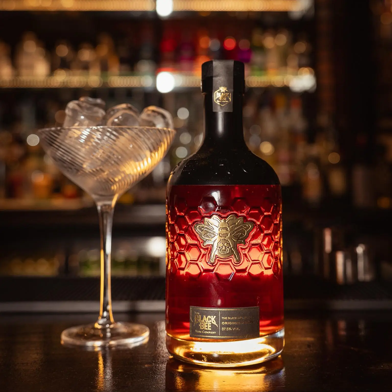 A bottle of rum and a cocktail glass